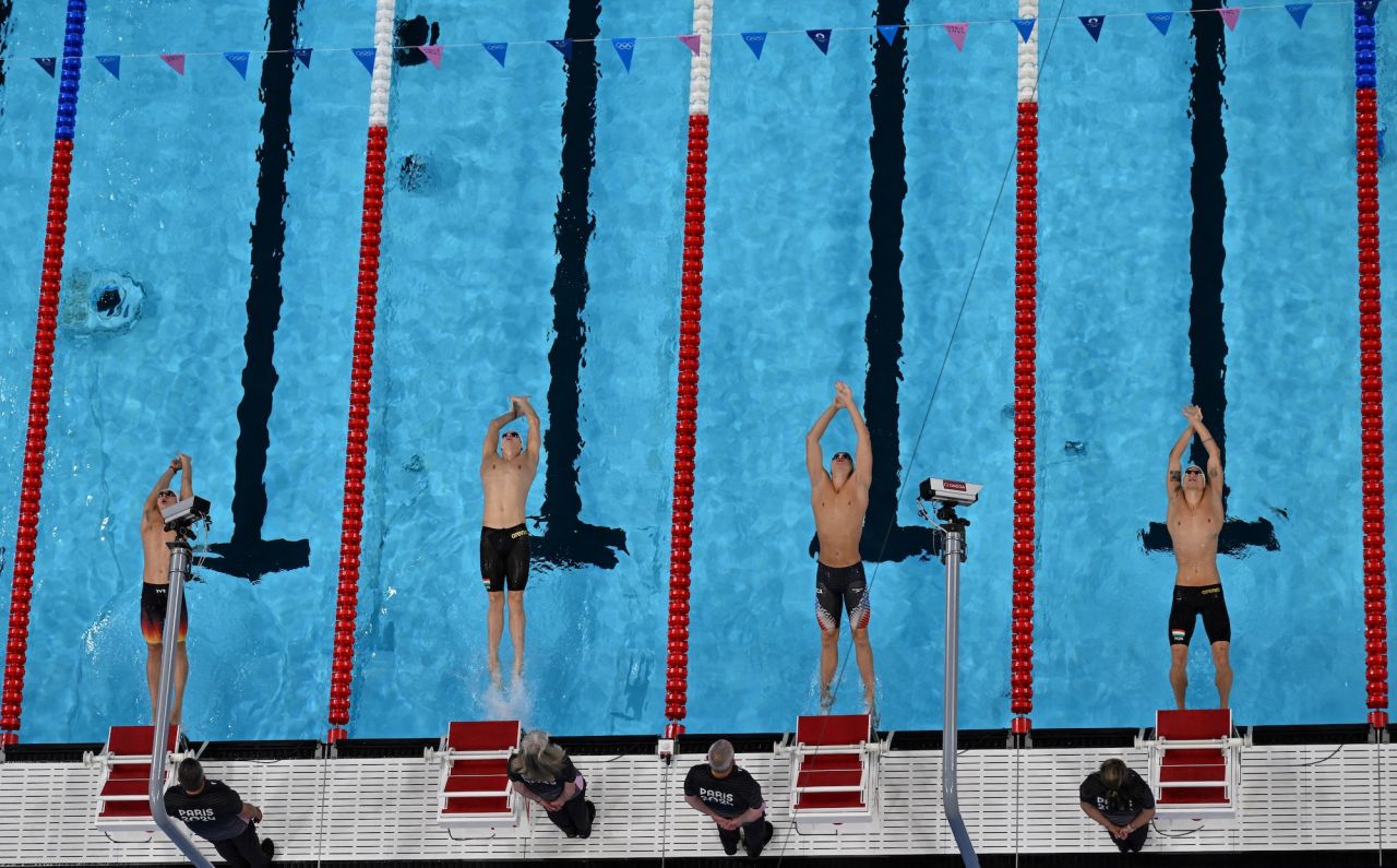 Swimmers dive into the pool for the men's 200m backstroke swimming event at the Paris La Defense Arena in Nanterre on Wednesday,