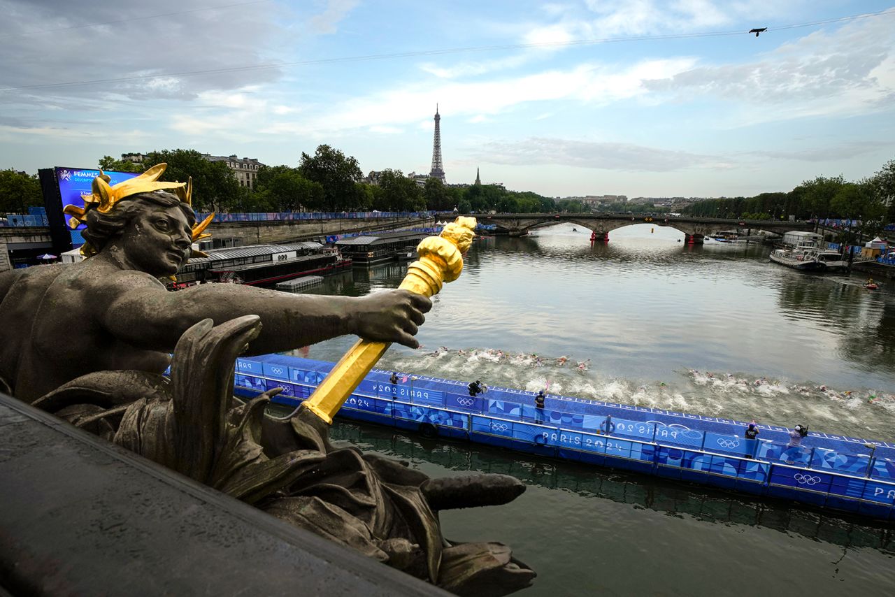 Athletes dive into the water for the start of the women's individual triathlon competition at the 2024 Summer Olympics, on July 31, in Paris, France. 