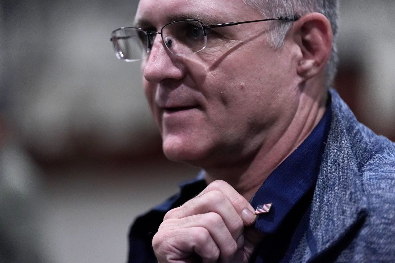 Paul Whelan displays an American flag pin he received from President Joe Biden as he arrives at Kelly Field in San Antonio, Texas, on Friday.