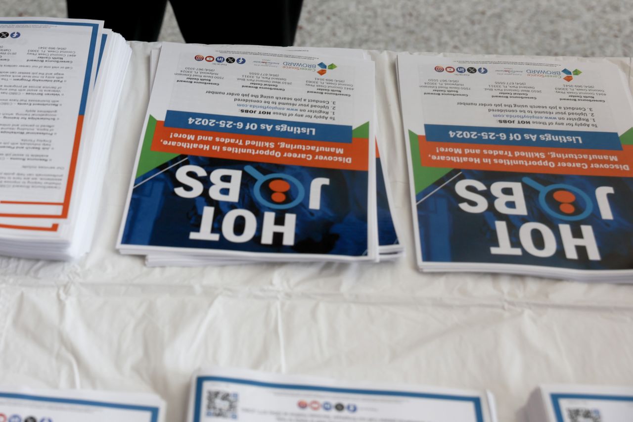 A company advertises to job seekers during the JobNewsUSA.com South Florida Job Fair held at the Amerant Bank Arena on June 26 in Sunrise, Florida.