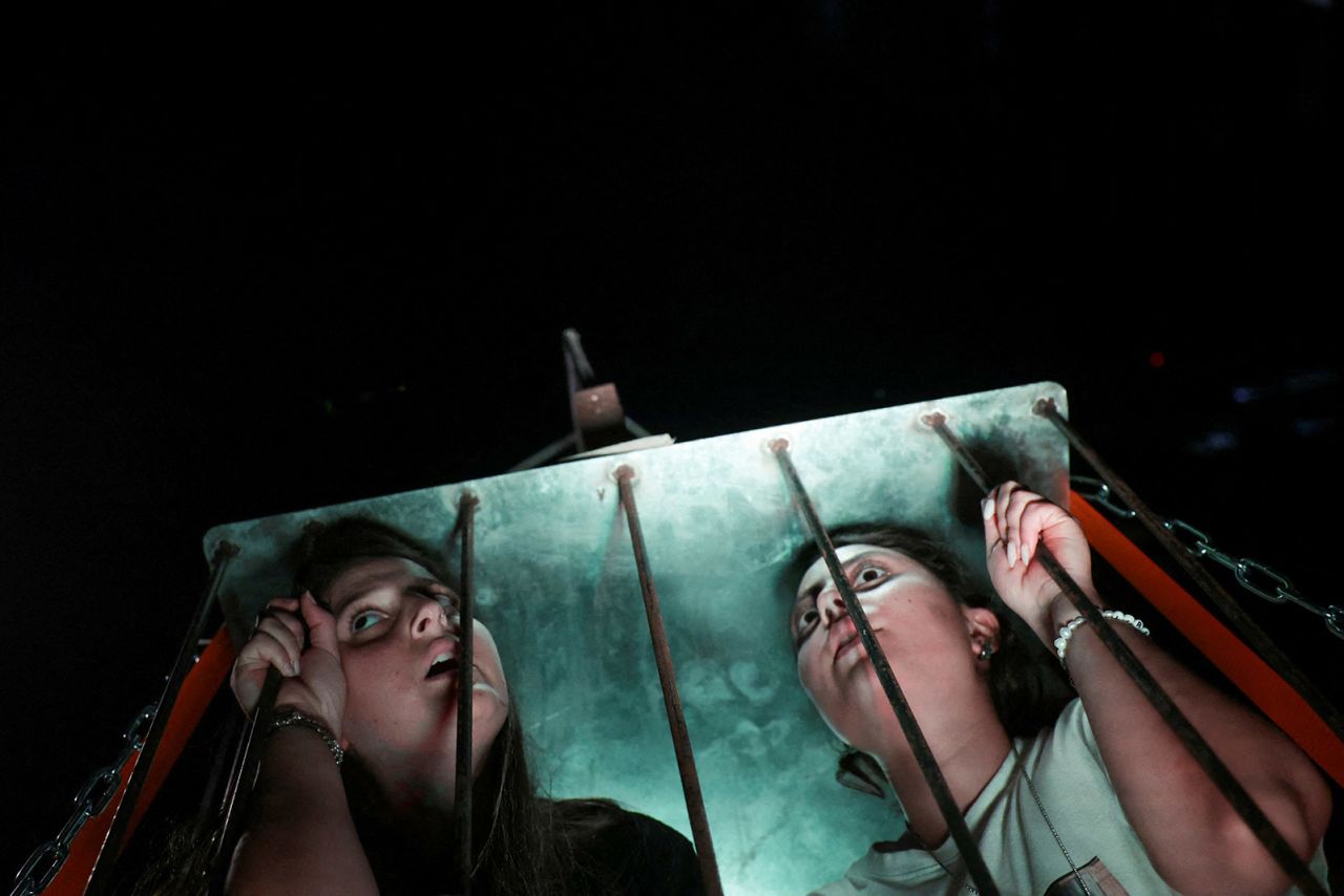 Demonstrators sit inside a cage, as they take part in a march marking 300 days since the deadly October 7 attack and calling for an immediate release of hostages being held in Gaza, in Tel Aviv, Israel, on August 1.