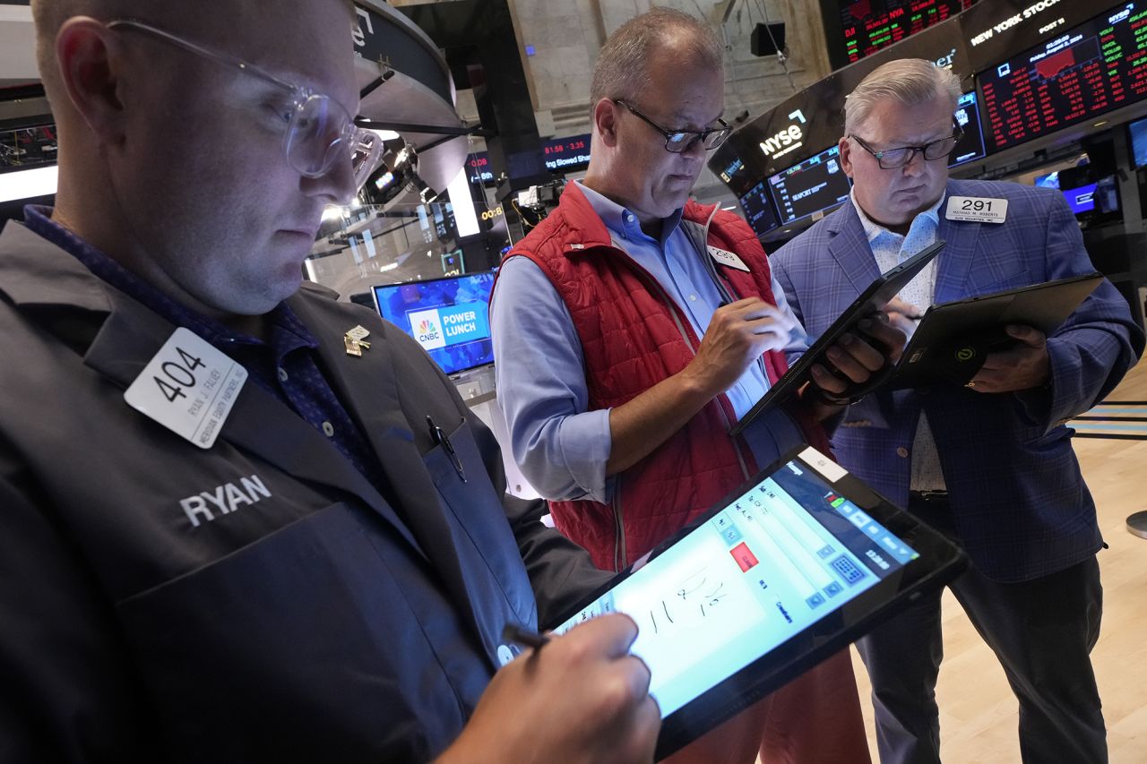 A trio of traders work on the floor of the New York Stock Exchange, on Friday, Aug. 2.