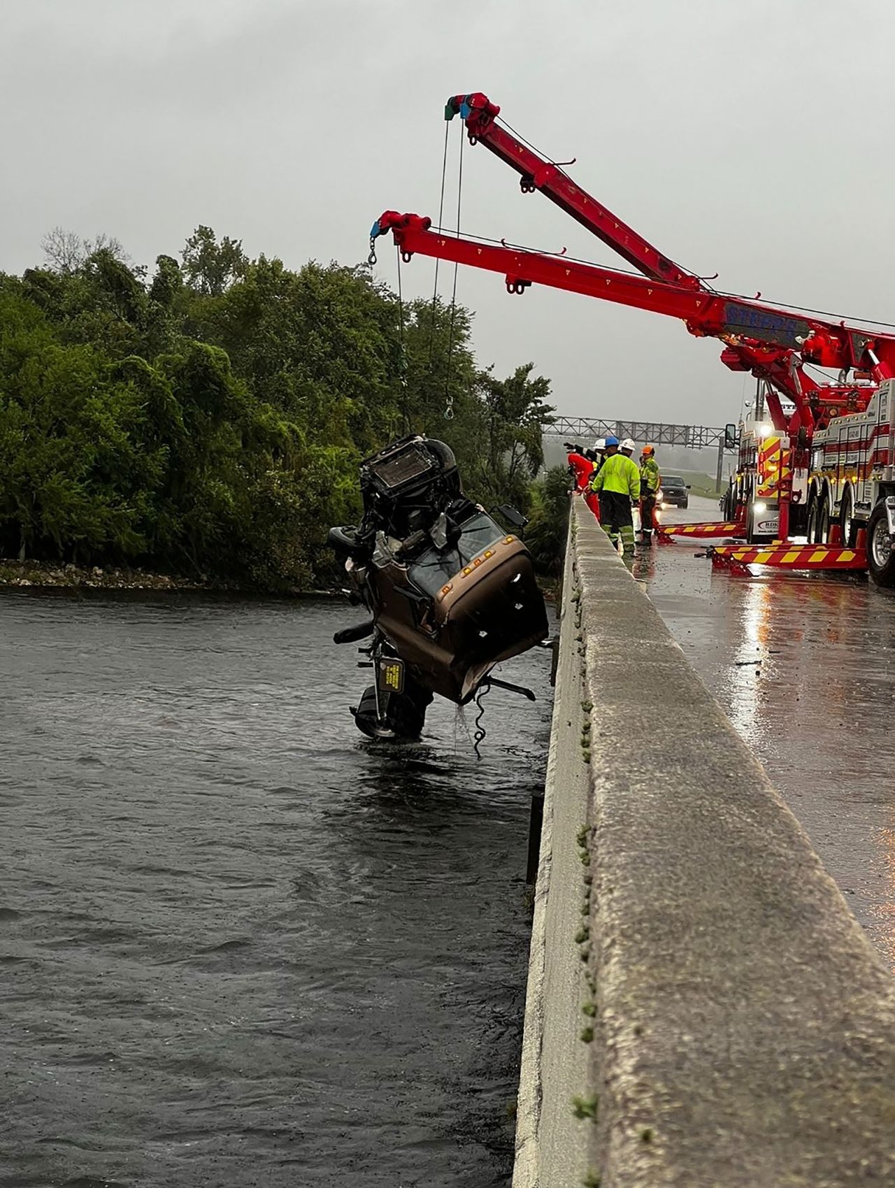 A tractor-trailer is lifted from a canal near Tampa, Florida, on Monday.