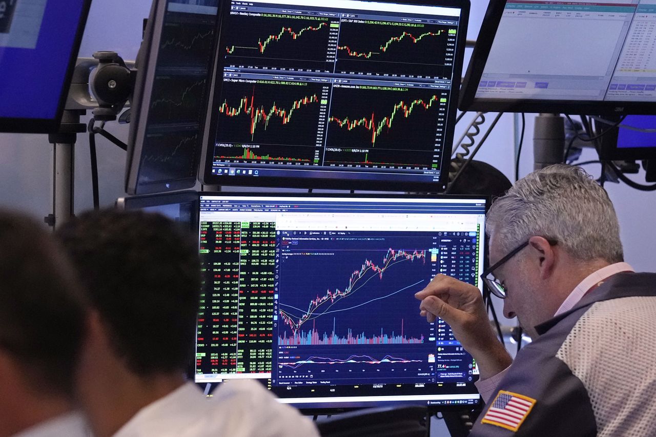 Traders work on the floor of the New York Stock Exchange on Tuesday, August 6.