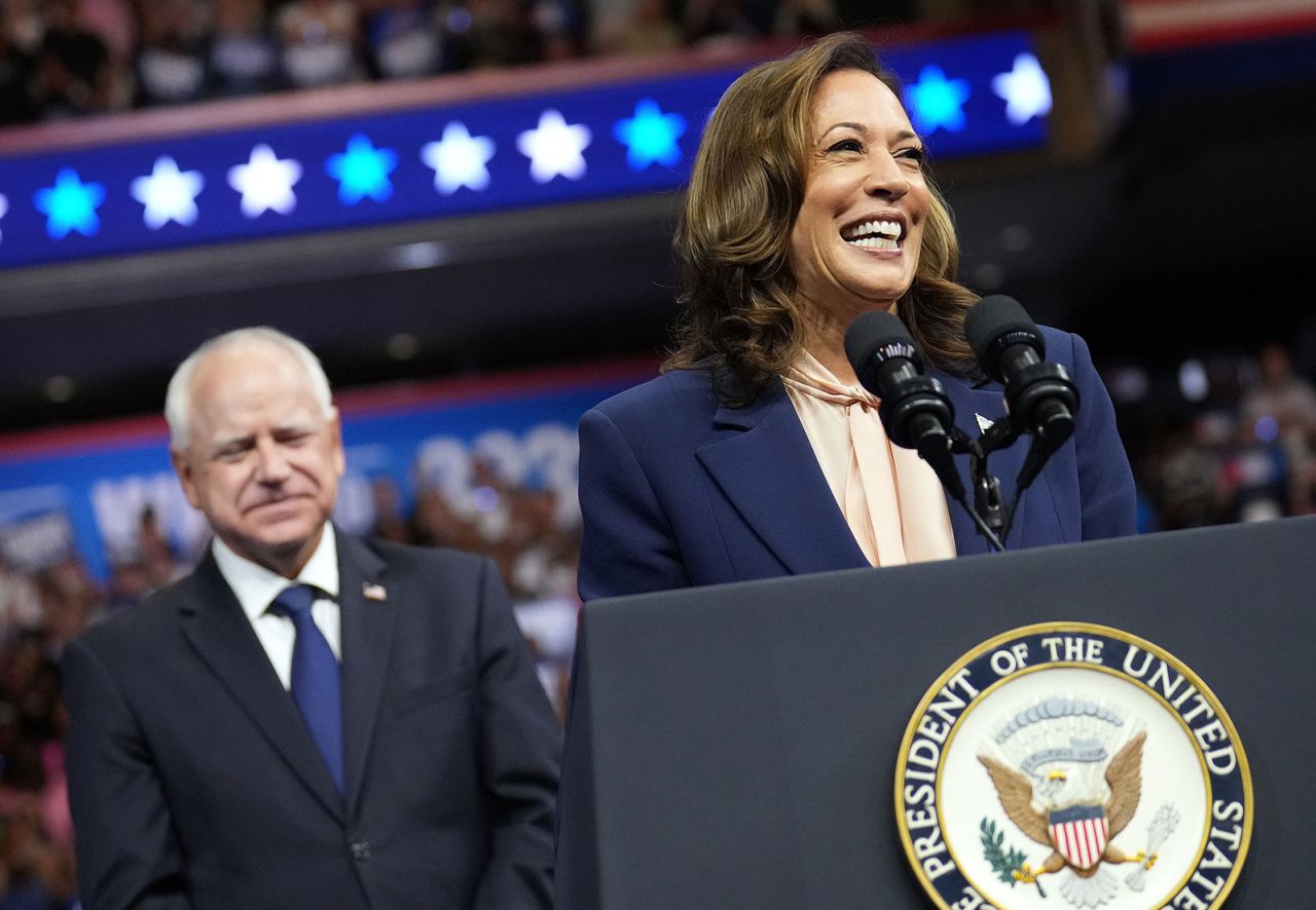 Democratic presidential candidate, Vice President Kamala Harris speaks as Democratic vice presidential candidate Minnesota Gov. Tim Walz looks on.