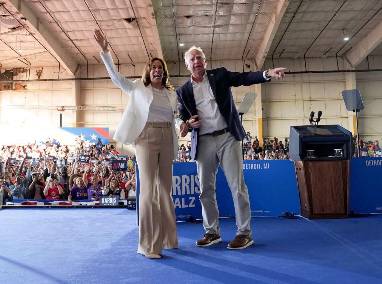 Vice President Kamala Harris and running mate Minnesota Gov. Tim Walz appear on stage together during a campaign event in Romulus, Michigan, on August 7. 