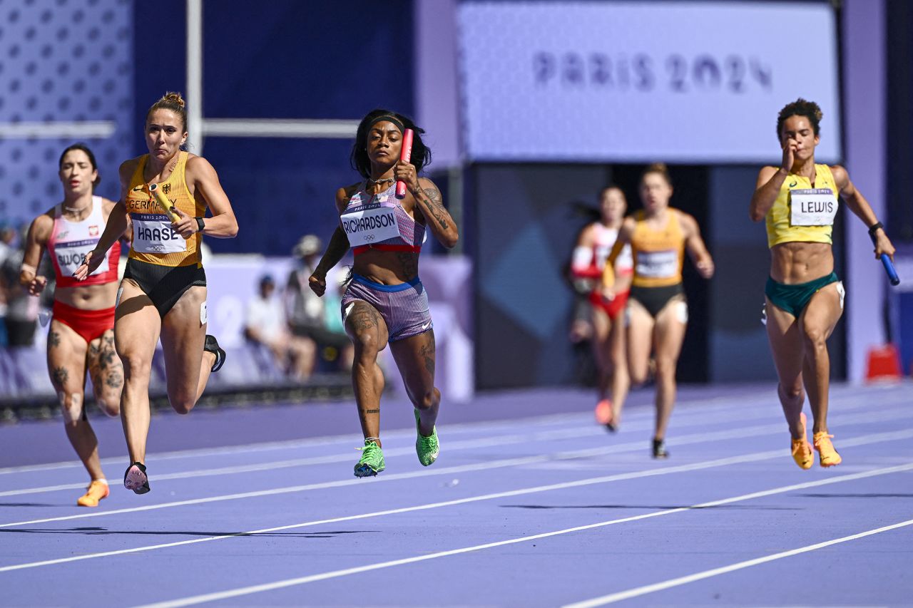 US' Sha'Carri Richardson, center, leads ahead of Germany's Rebekka Haase and Australia's Torrie Lewis in the women's 4x100m relay heat of the athletics event at the Paris 2024 Olympic Games at Stade de France in Saint-Denis on August 8.