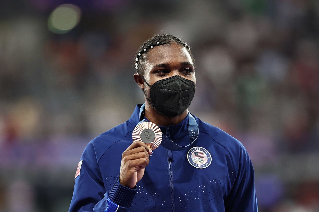 Bronze medallist Noah Lyles celebrates on the podium during the victory ceremony for the men's 200m on August 9.