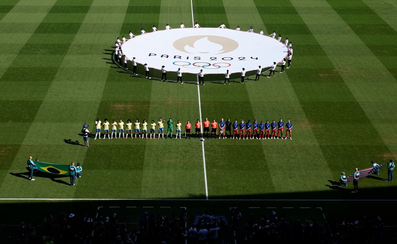 Brazil and US players line up during the national anthems before the match on August 10. 