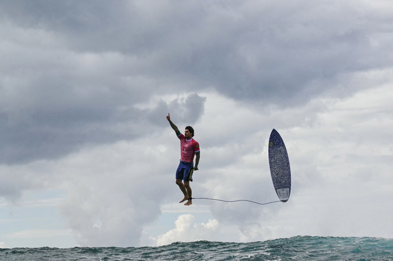 Brazilian surfer Gabriel Medina leaps from his surfboard and raises his finger in the air as he celebrates a near-perfect 9.90-scoring wave on July 29. It was the highest-scoring wave in Olympic history.