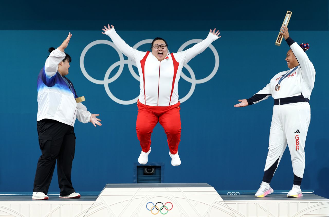 Li, center, celebrates on the podium alongside South Korea's Park Hyejeong, left, and Great Britain's Emily Campbell, right, on Sunday. 