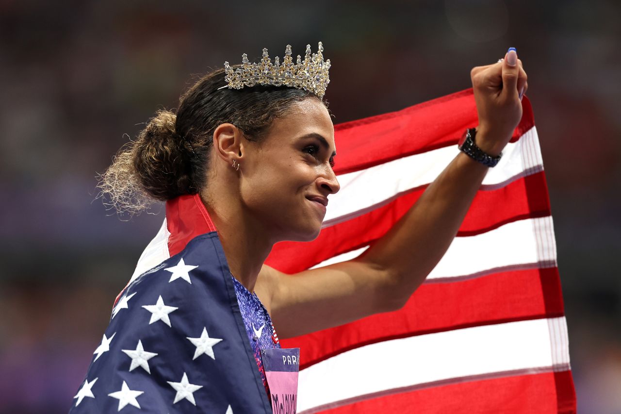 US athlete Sydney McLaughlin-Levrone wears a crown after winning the 400-meter hurdles and smashing her own world record on August 8. She finished in 50.37 seconds, dominating the field to win gold for the second straight Olympics.