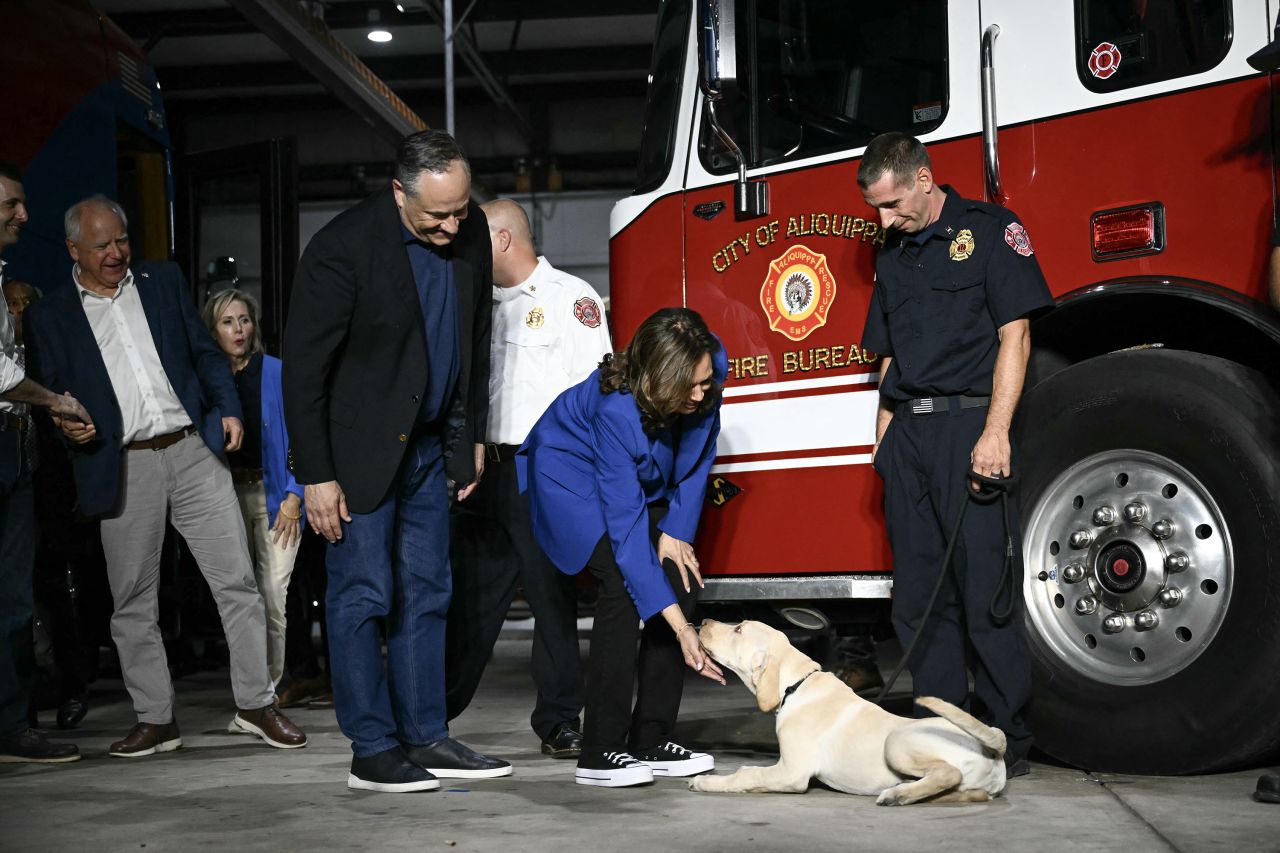 Vice President Kamala Harris pets a dog as she arrives at a fire station in Aliquippa, Pennsylvania, on August 18.