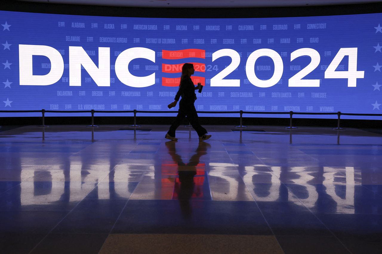 An attendee walks past a screen at the United Center, ahead of the Democratic National Convention today in Chicago, Illinois.