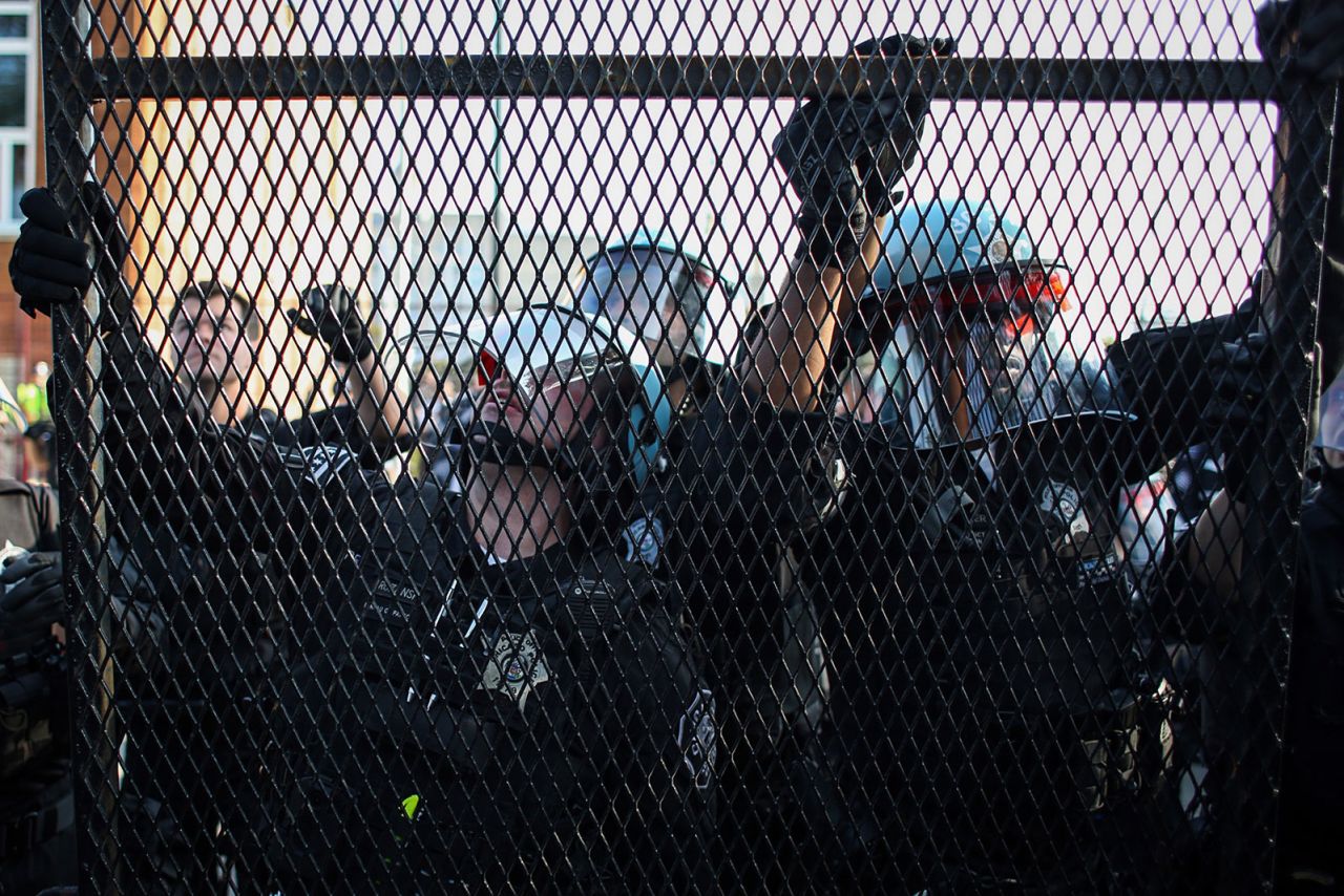 Chicago police secure fencing after a breach in the security barrier ahead of the Democratic National Convention on Monday, August 19, in Chicago.