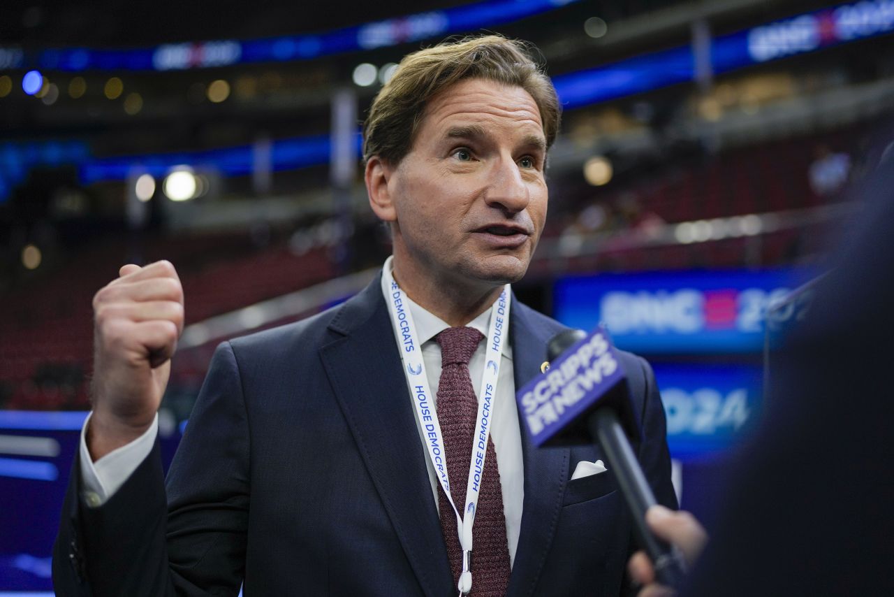 Rep. Dean Phillips talks on the floor before the Democratic National Convention on August 19, in Chicago.