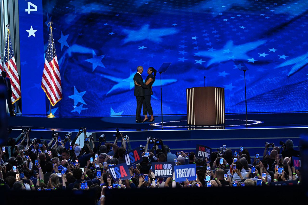 Former President Barack Obama and Michelle Obama embrace on stage on Tuesday, August 20, during the DNC in Chicago.