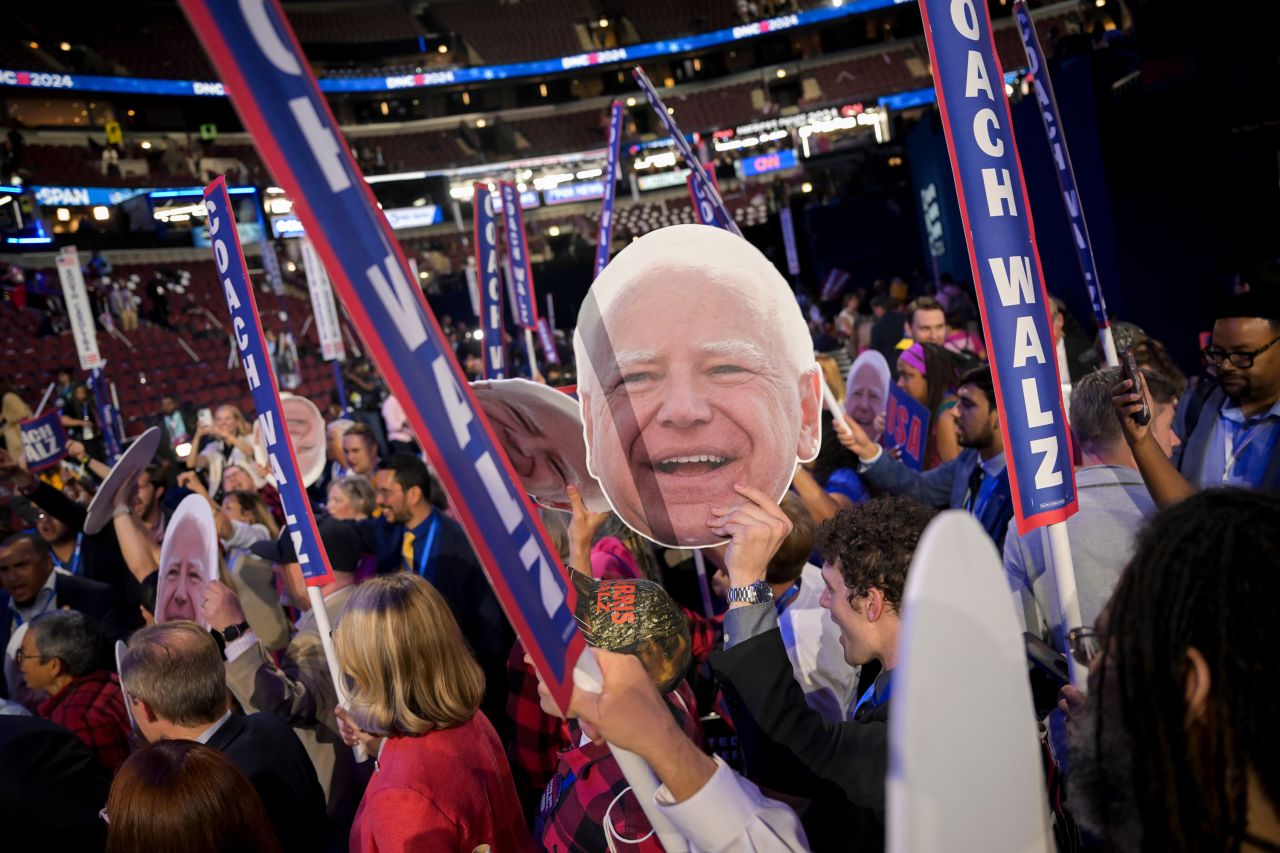 Delegates hold cutouts of Tim Walz, governor of Minnesota and Democratic vice-presidential nominee, during the Democratic National Convention (DNC) at the United Center in Chicago, on August 21.