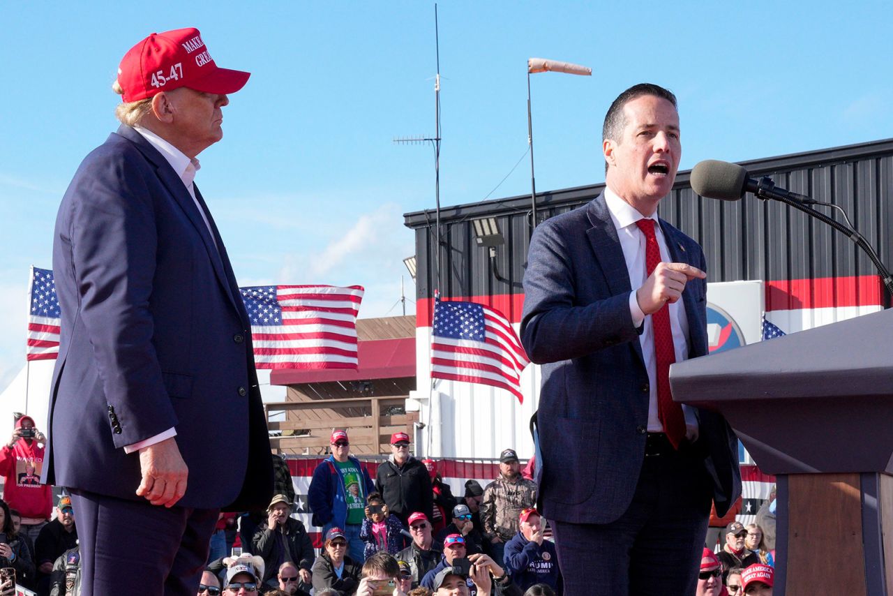 Senate candidate Bernie Moreno speaks at a campaign rally in March in Vandalia, Ohio, as Former President Donald Trump looks on.