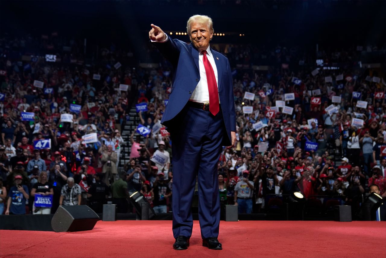 Former President Donald Trump points to supporters at a campaign rally on August 23, in Glendale, Arizona. 