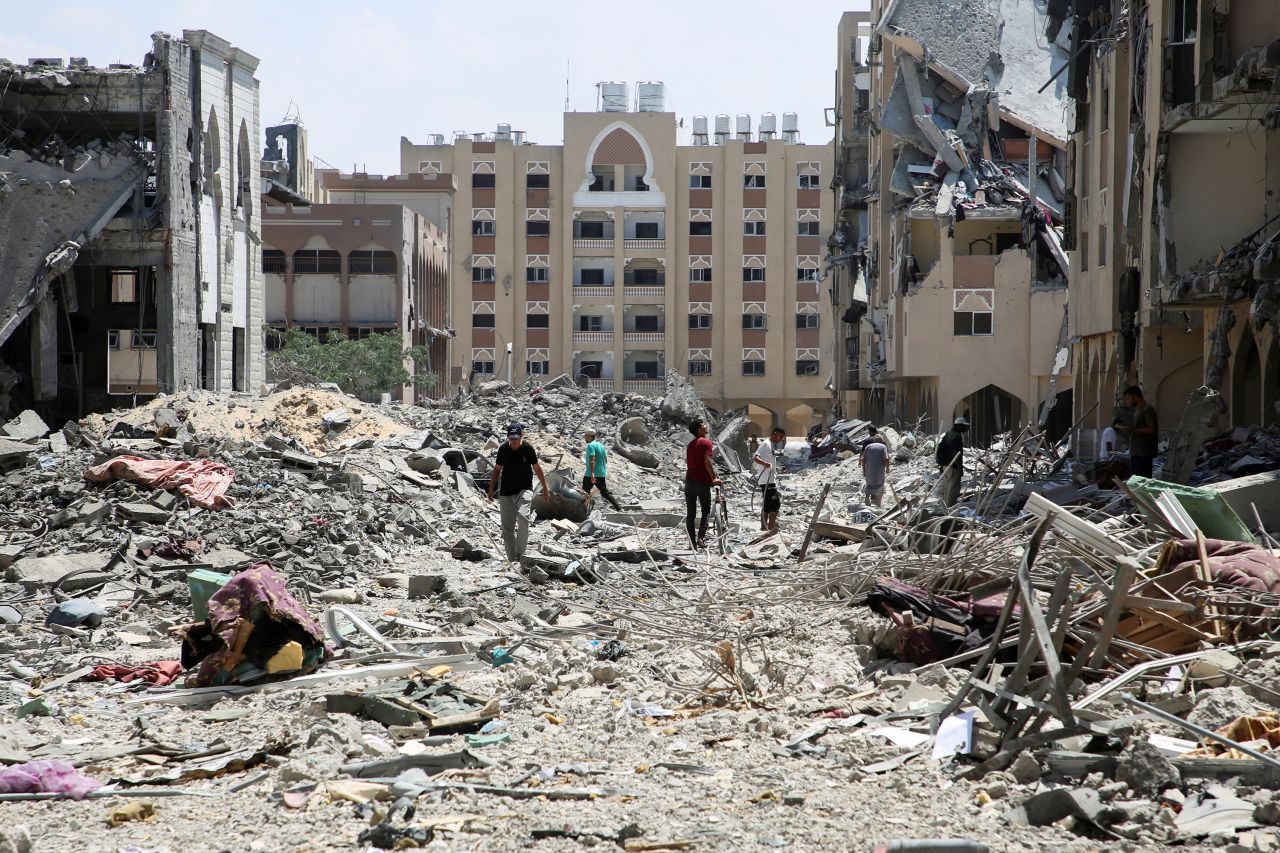 Palestinians inspect damage following an Israeli raid in Khan Younis, Gaza, on August 24. 