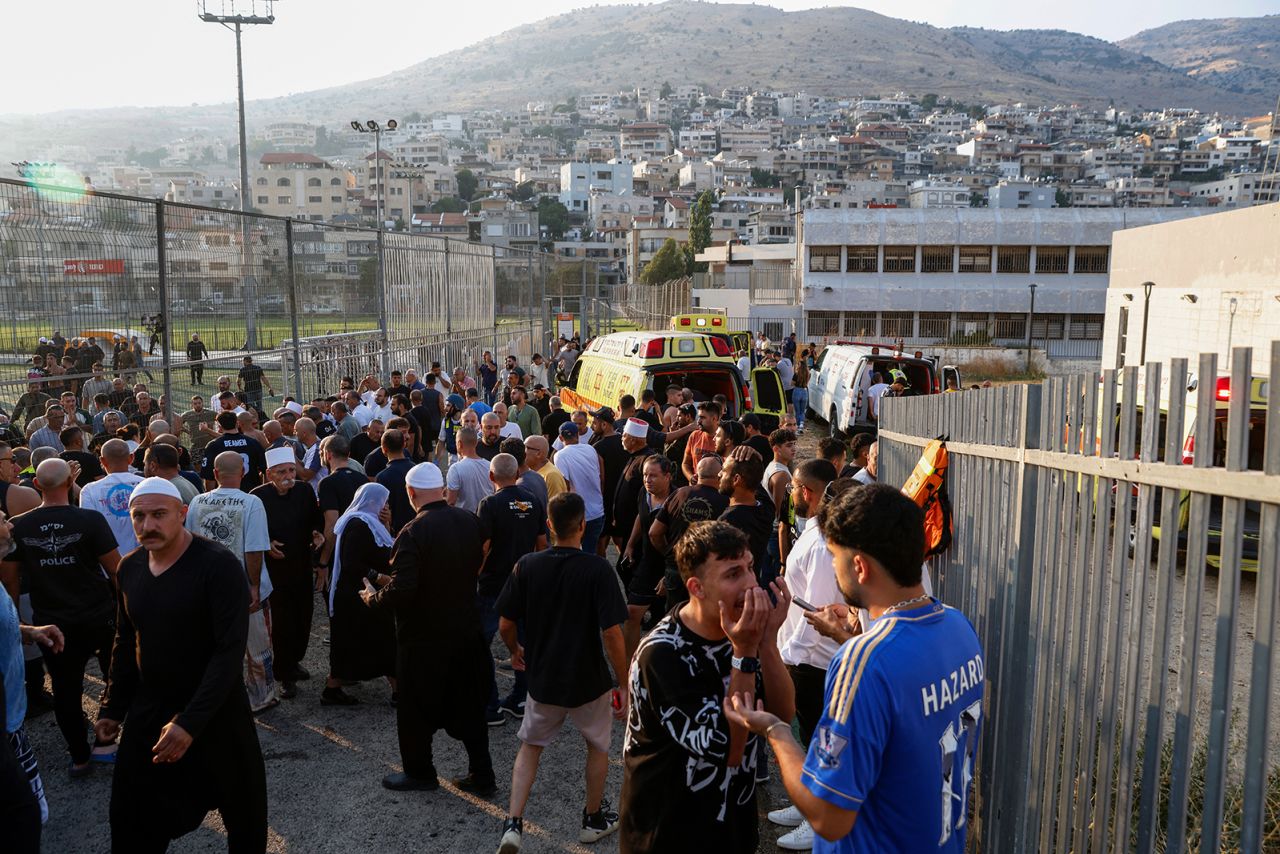 Israeli emergency services and local residents gather near a site where a reported strike from Lebanon fell in Majdal Shams village in the Israeli-annexed Golan area on July 27.