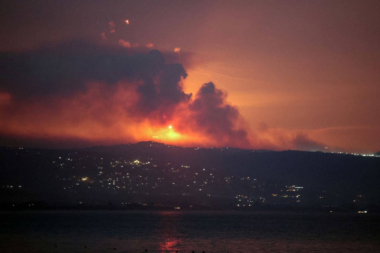 A view shows smoke and fire on the Lebanese side of the border with Israel, after Israel said it had carried out strikes on Hezbollah targets in Lebanon, as seen from Tyre, southern Lebanon, on August 25.