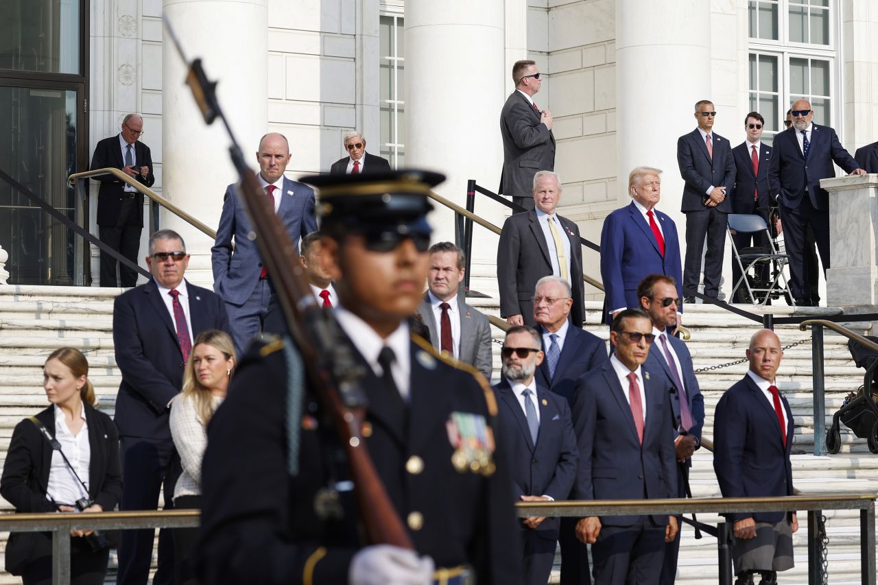 Former President Donald Trump observes a changing of the guard at Arlington National Cemetery in Virginia on August 26.