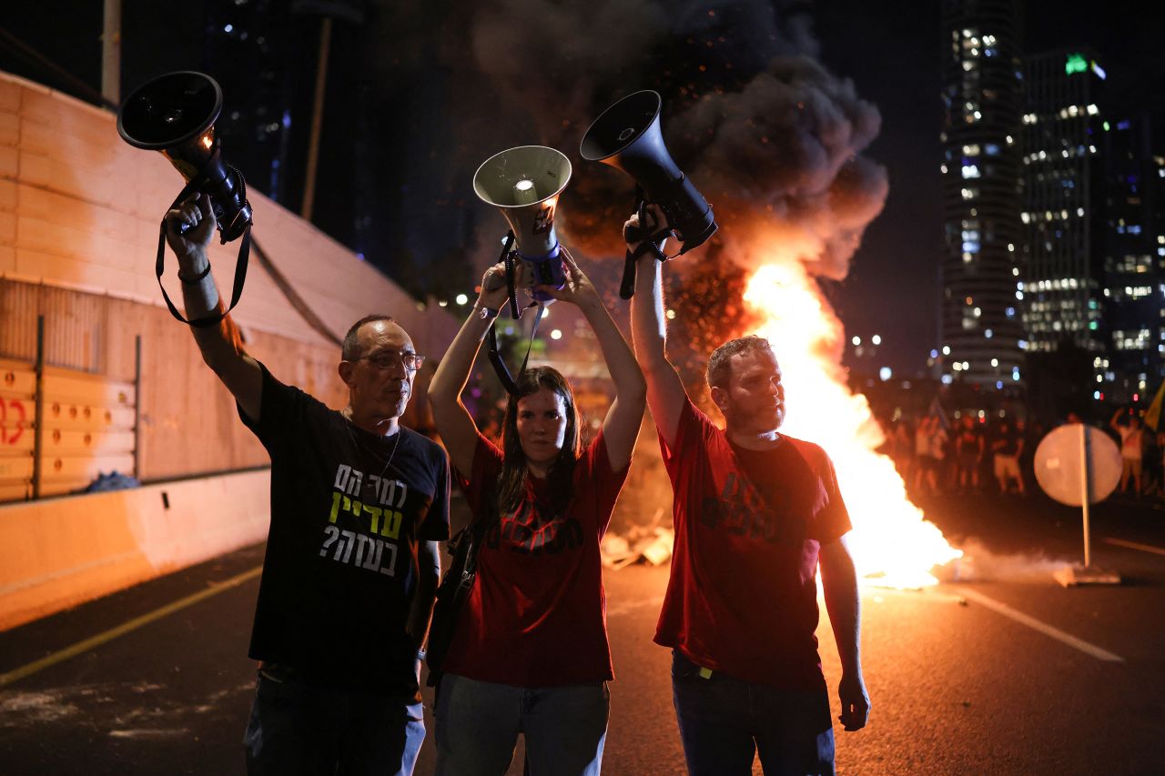 Protesters raise their megaphones as they block Tel Aviv's Ayalon highway during an anti-government rally calling for the release of Israelis held hostage by Palestinian militants in Gaza since October, on September 1.