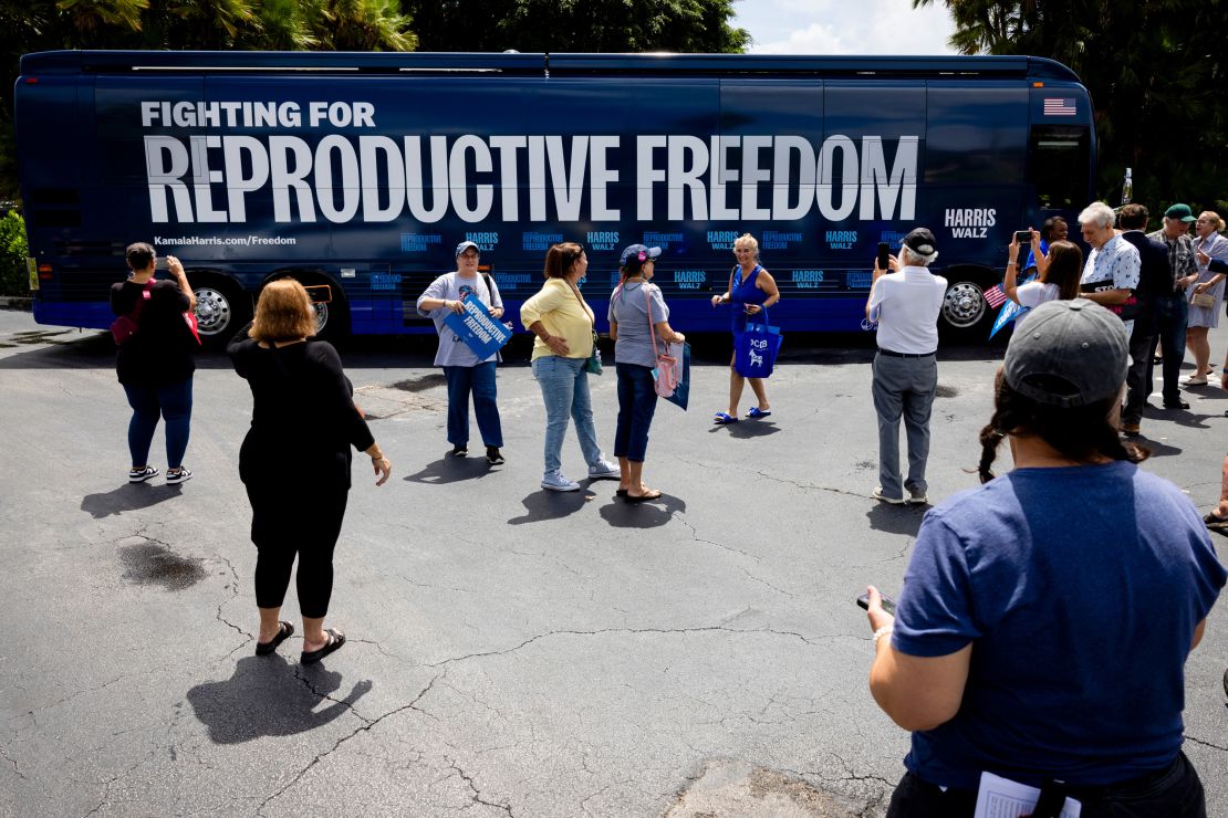 People take photos of the Reproductive Freedom Bus during the kickoff of the Harris-Walz campaign reproductive rights bus tour in Boynton Beach, Florida, on September 3.