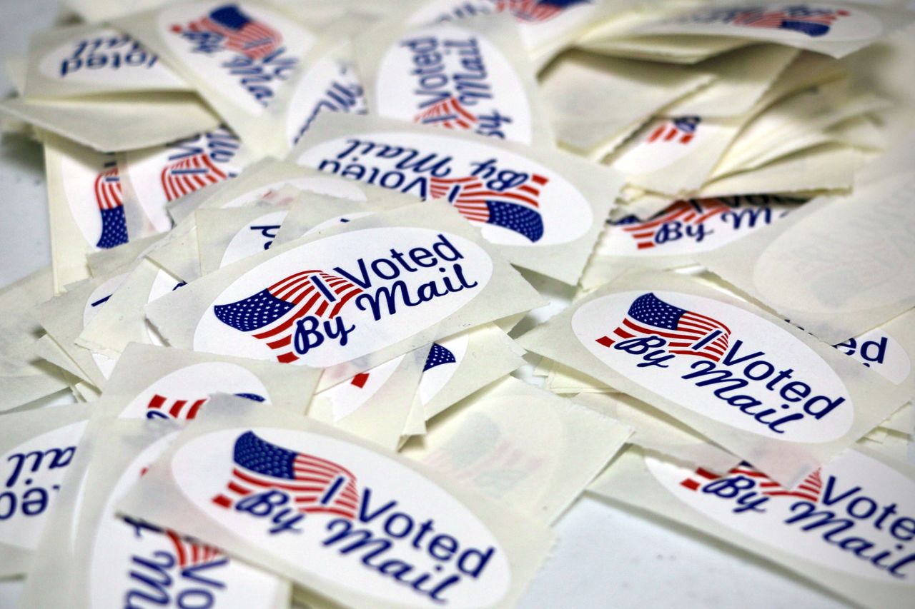 Stickers reading "I Voted By Mail" are displayed as the Wayne County Board of Elections prepares absentee ballots in Goldsboro, North Carolina, in September 2022.