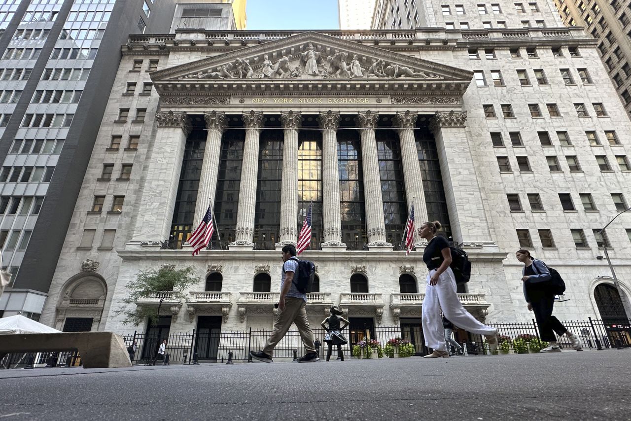 People pass the New York Stock Exchange on Wednesday, September 4.