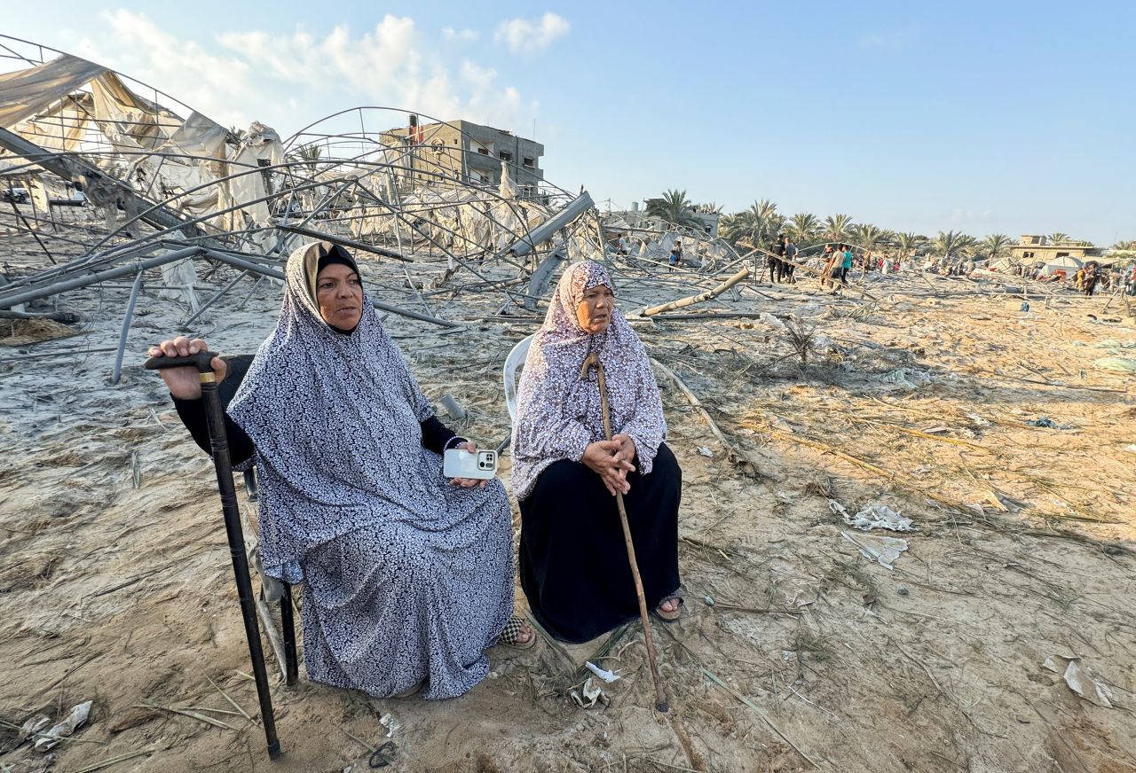 Palestinian women sit at the site following Israeli strikes on a tent camp sheltering displaced people in Al-Mawasi, Khan Younis, on September 10.