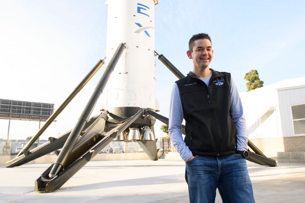 Inspiration4 mission commander Jared Isaacman stands for a portrait in front of a Falcon 9 rocket at SpaceX facilities in Hawthorne, California, in February 2021.