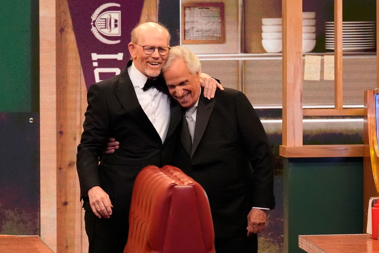 Ron Howard and Henry Winkler embrace while presenting the award for outstanding directing for a comedy series. 