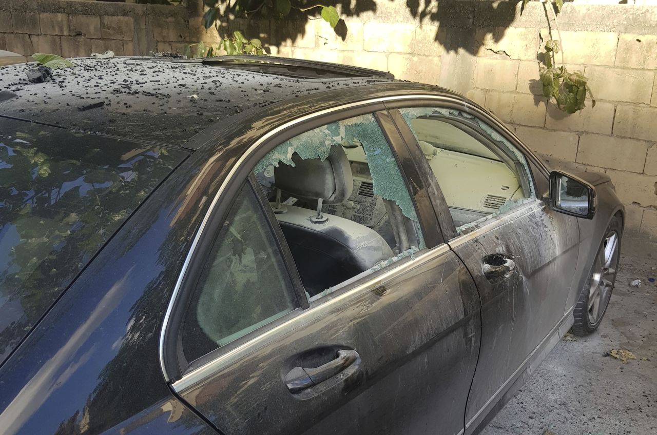 A partly damaged car is seen after a small explosion, in the southern port city of Sidon, Lebanon, on Wednesday.