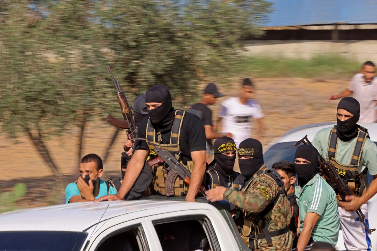 Palestinian militants move towards the border fence with Israel from Khan Younis in southern Gaza, on October 7, 2023. 