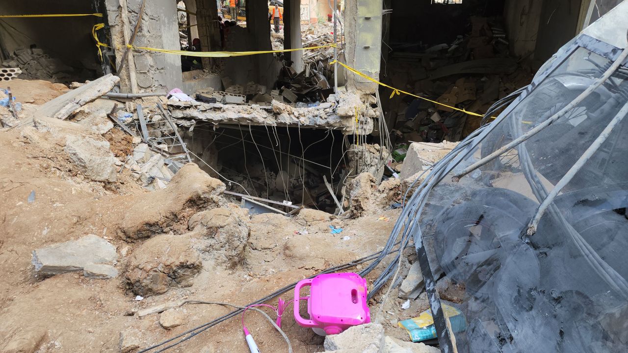 The Israeli strike leveled a building in Beirut and destroyed the ground floor of an adjacent building, pictured Saturday. Civil Defense teams continue removing the rubble in the background. 