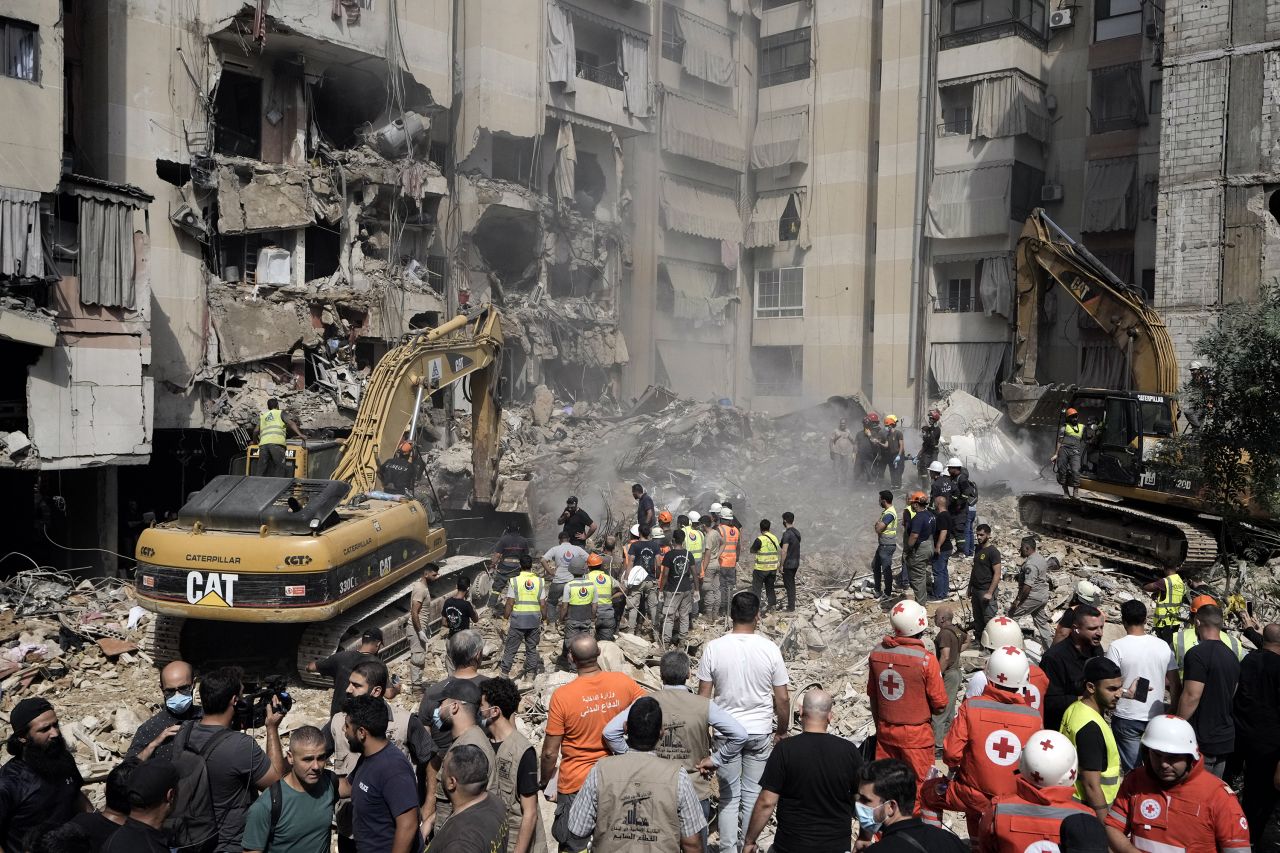 Emergency workers use excavators to clear the rubble at the site of an Israeli strike in Beirut’s southern suburb in Lebanon on September 21.