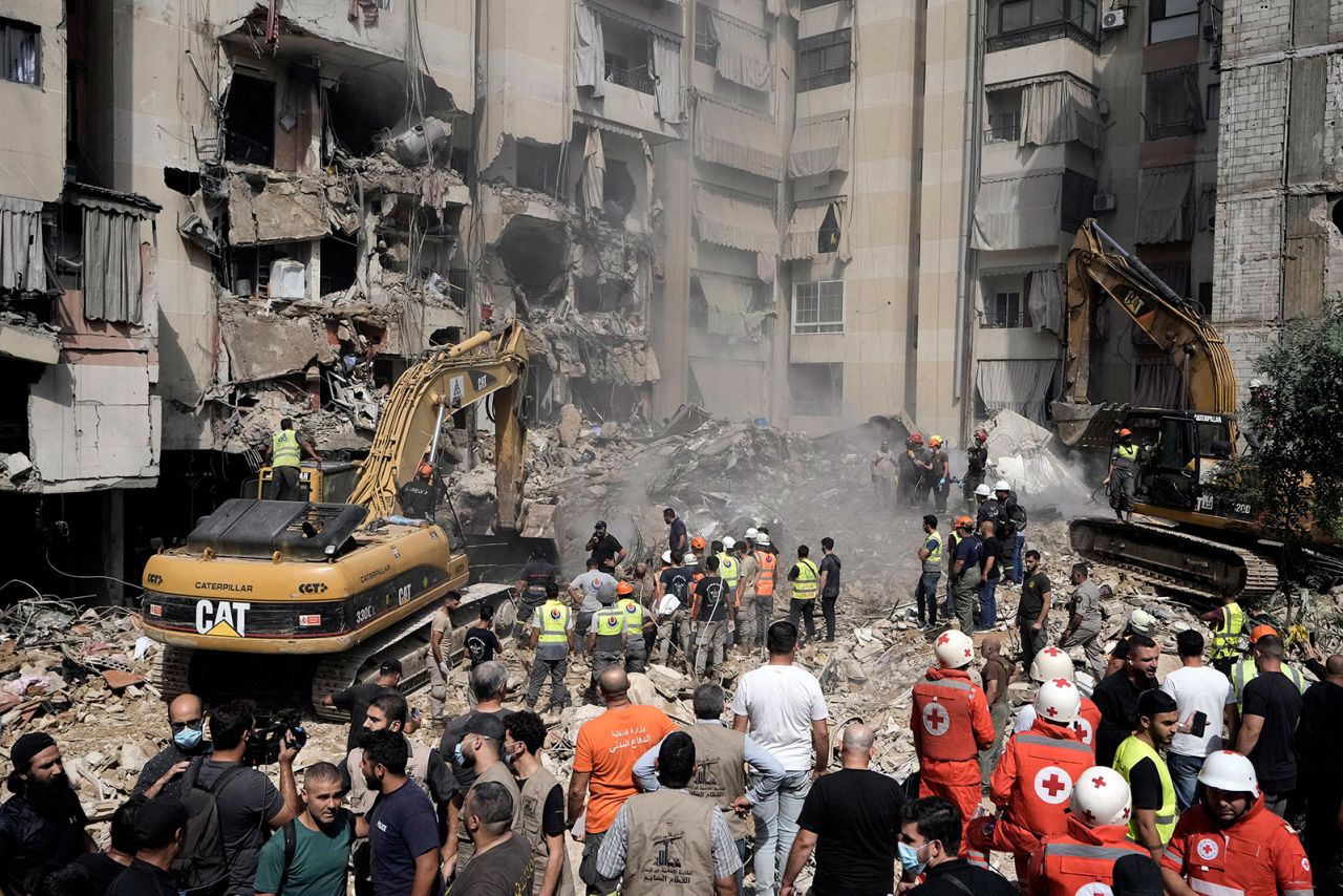 Emergency workers use excavators to clear the rubble at the site of an Israeli strike in Beirut’s southern suburb in Lebanon on September 21. 