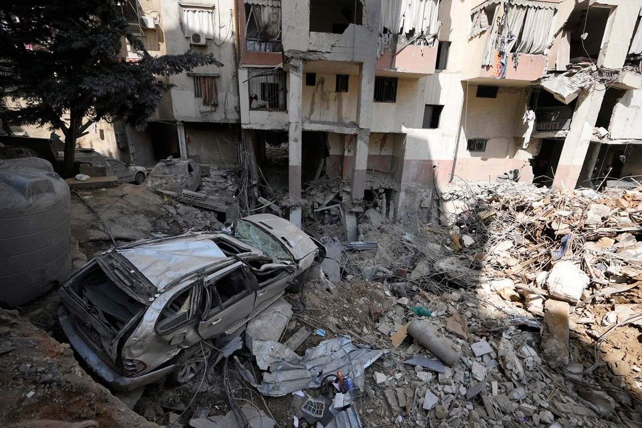 On September 21, a damaged car stands on the rubble of a building at the site of the Israeli attack in the southern suburbs of Beirut.