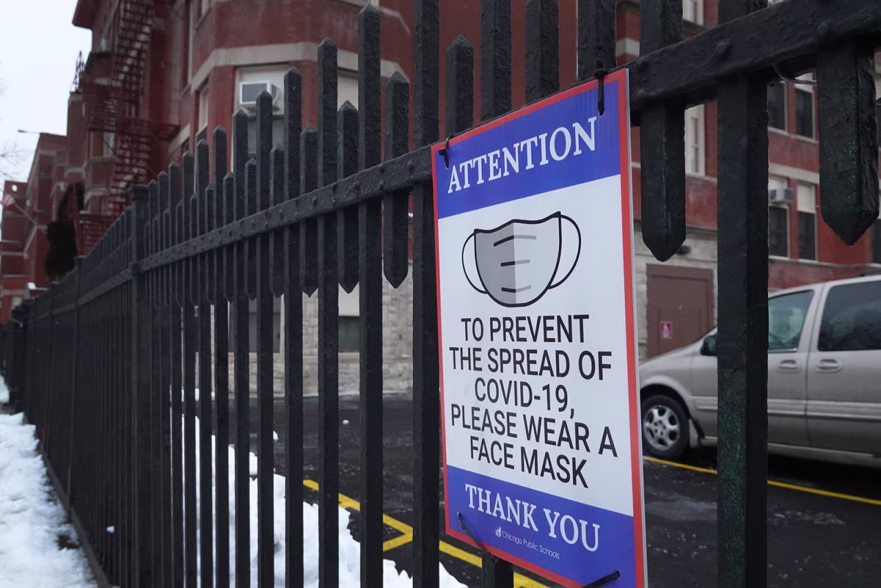 A sign is seen on the fence outside of Lowell elementary school on January 5 in Chicago, Illinois. Classes at all of Chicago public schools have been canceled today by the school district after the teacher's union voted to return to virtual learning, citing unsafe conditions in the schools as the Omicron variant continues to spread. 