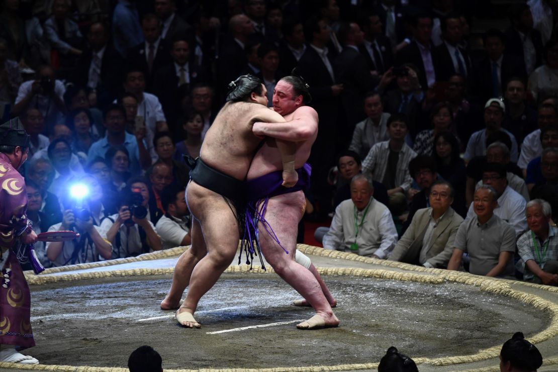 Sumo wrestler Tochinoshin of Georgia (right) battles Takayasu of Japan (left) during the Summer Grand Sumo Tournament in Tokyo on May 26, 2019. 