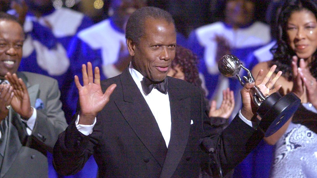 Sidney Poitier signals to the audience to sit after being presented with a Hall of Fame Tribute at the 32nd Annual NAACP  Image Awards in Los Angeles  in 2001. 