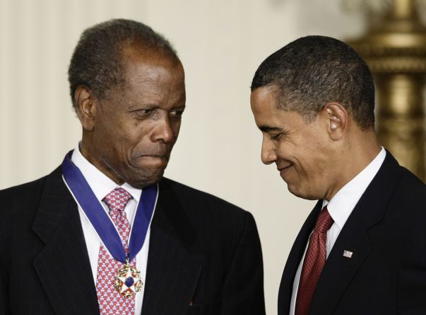 President Barack Obama talks with Poitier after presenting him with the Presidential Medal of Freedom in 2009. "It's been said that Sidney Poitier does not make movies, he makes milestones — milestones of artistic excellence; milestones of America's progress," Obama said during the ceremony. "On screen and behind the camera, in films such as 'The Defiant Ones,' 'Guess Who's Coming to Dinner,' 'Uptown Saturday Night,' 'Lilies of the Field' — for which he became the first African American to win an Academy Award for best actor — Poitier not only entertained, but enlightened, shifting attitudes, broadening hearts, revealing the power of the silver screen to bring us closer together."