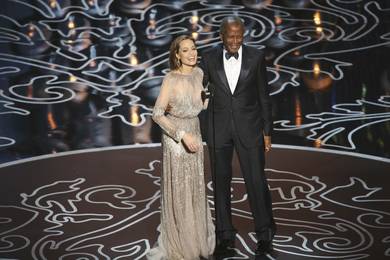 Poitier and actress Angelina Jolie present an Academy Award together in 2014.