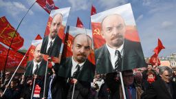 Russian Communist party members and supporters carry portraits of Vladimir Lenin as they walk towards the Mausoleum of the Soviet state founder and revolutionary leader Vladimir Ilyich Ulyanov aka Lenin to attend a flower-laying ceremony marking the 151th anniversary of his birth, on Red Square in Moscow, April 22, 2021. (Photo by NATALIA KOLESNIKOVA / AFP) (Photo by NATALIA KOLESNIKOVA/AFP via Getty Images)