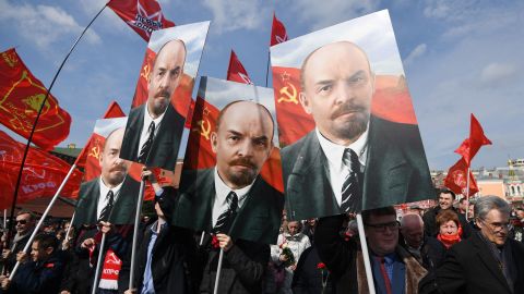 Russian Communist Party supporters carry portraits of Vladimir Lenin as they walk toward the mausoleum of the Soviet state founder on the 151th anniversary of his birth.