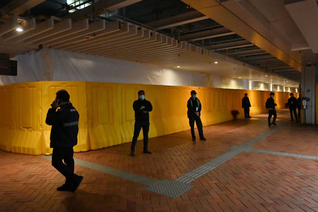 Security guards stand in front of barriers erected around the 26-foot-tall "Pillar of Shame."