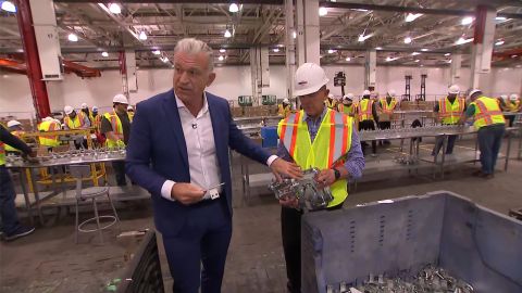 Dylan Ratigan, left, details a component near the assembly line.